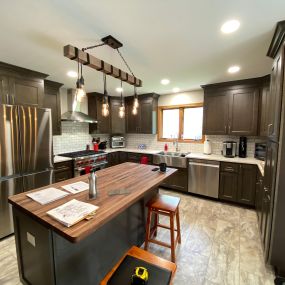 Create a rich look on a reasonable budget using stock kitchen cabinetry