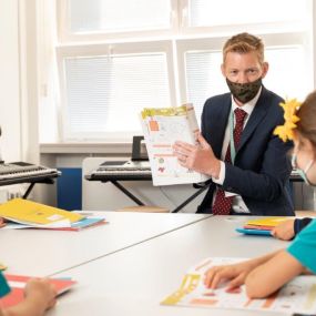 Prague British International School - primary school headmaster with children in masks