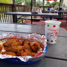 Delicious spicy lemon pepper wings with a cool cup of water on our beautiful and spacious deck!