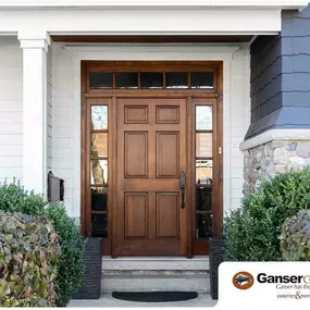 Beautiful entry door surrounded by decorative fixed windows.