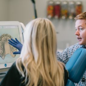 Dr. Kyle Fagala explaining a digital impression to a patient. We have an iTero Element scanner at Saddle Creek Orthodontics. This technology replaces the gooey, gag-inducing impressions you may remember from when you were younger.