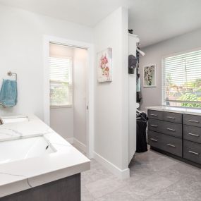 Master bathroom with an open floor plan. This bathroom included a lot of storage space and a separate space for the toilet.