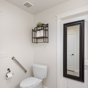 Removed wall separating the toilet from the rest of the bathroom.