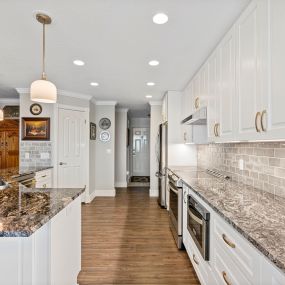 Steel Grey Granite countertops, KCD Napa White  Soft Close cabinets with Melamine interior