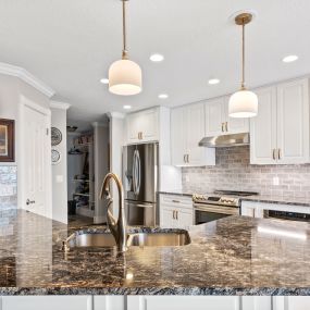 Steel Grey Granite countertops, KCD Napa White  Soft Close cabinets with Melamine interior