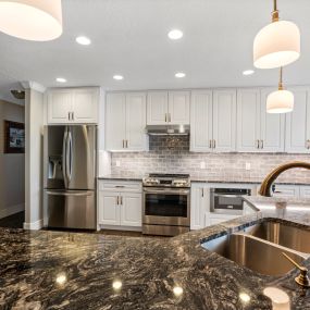 Steel Grey Granite countertops, KCD Napa White  Soft Close cabinets with Melamine interior