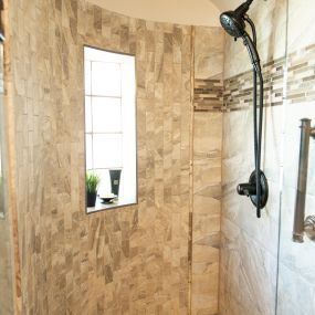 The shower floor is a hemisphere pebble mosaic tile in Antigua. The wall tile consists of a 12