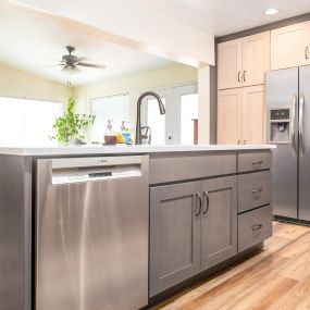 Two-toned kitchen cabinets, subway backsplash tile, LVP flooring, countertops, sink, appliances