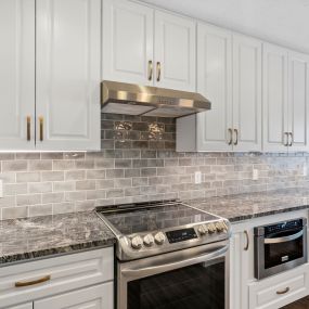 Steel Grey Granite countertops, KCD Napa White  Soft Close cabinets with Melamine interior