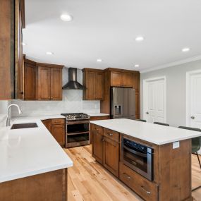 Crown cabinets, Alder wood, wheat finish, onyx glaze, cascade XL door with profile #7, slab drawers, upgrade glides, and full overlay.  Natural maple laminate interior and underside of cabinets