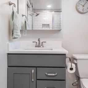 Brightened basement bathroom. This remodel included paint, new vanity cabinet, medicine cabinet, faucet, toilet, baseboards, countertop, flooring, etc.