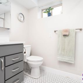 Brightened basement bathroom. This remodel included paint, new vanity cabinet, medicine cabinet, faucet, toilet, baseboards, countertop, flooring, etc.