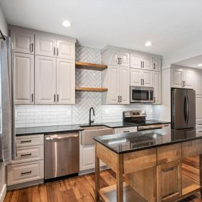 Showplace Cabinetry in gunsmoke paint, kitchen floating shelves, SLCC  Island Collection - Sea Home LVP flooring, Square Boswell Cabinet Pulls