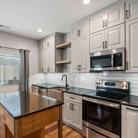 Showplace Cabinetry in gunsmoke paint, kitchen floating shelves, SLCC  Island Collection - Sea Home LVP flooring, Square Boswell Cabinet Pulls