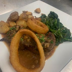 8oz Flat Iron Cooked to your desired Temperature Topped w/a Mushroom & Marsala Wine Demi-Glace Served w/Sautéed Spinach & Roasted Potatoes