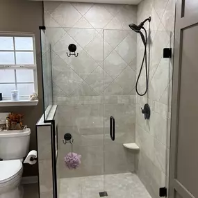 Custom tile shower with heavy glass Shower Door.