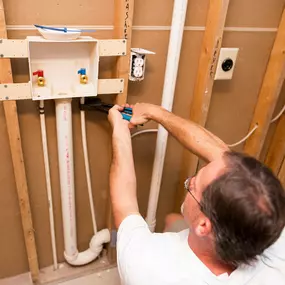 A plumber doing a water line repair and installation on the Outer Banks of North Carolina.