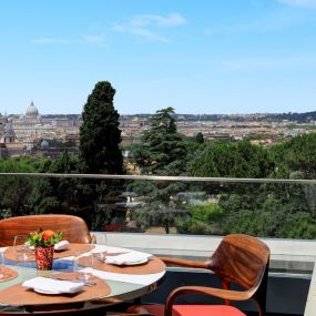 Round table on the open-air terrace at Il Giardino Ristorante, Hotel Eden Rome
