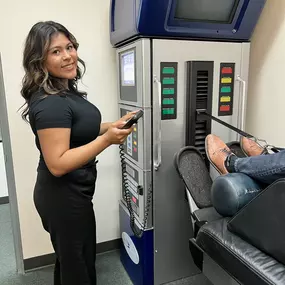 Luna, assistant, at Prieto Chiropractic & Spinal Decompression Center in Northern Orange County, helping a patient who is getting a spinal decompression treatment.