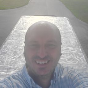 Founder of Energy Nerds, Michael Temple atop a 53 foot refrigerated trailer that was coated with Invisaflects Heat Reflective Coatings.  This picture was take prior to application but after the sanding preparation was completed.